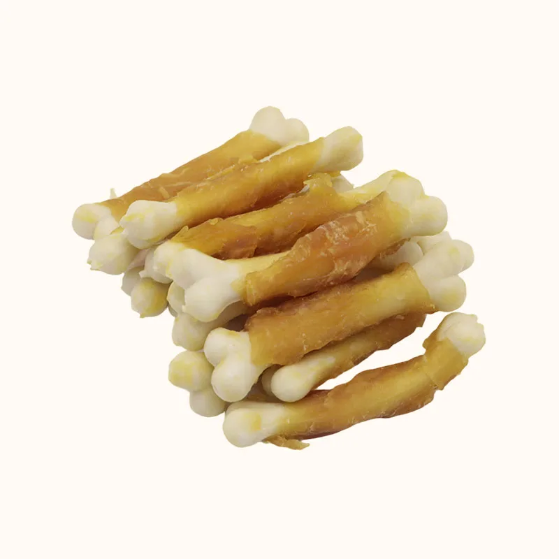 Pale bone-shaped dog treats wrapped with golden chicken around the middle