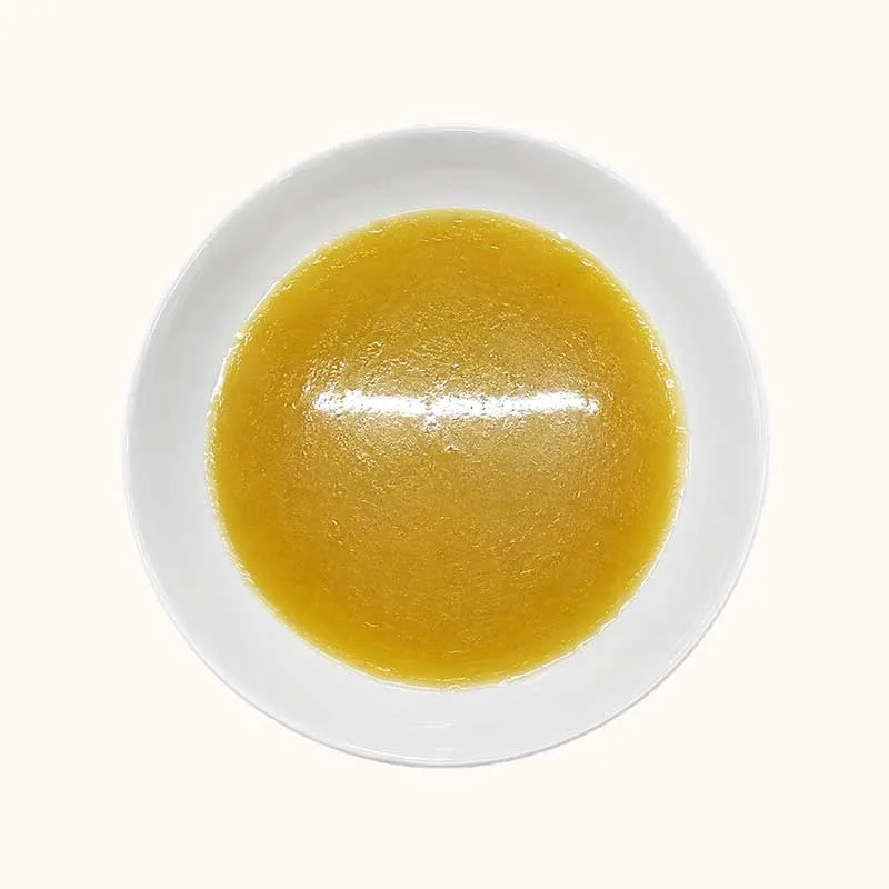 Golden soup in a white bowl for the Moisturizing Soup Pack cat food product